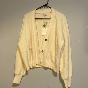 Cute cream colored cardigan with pockets and buttons.
